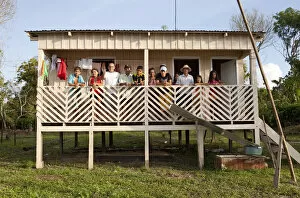 Images Dated 4th December 2012: South America, Brazil, Amazonas, Gero Mesquita and a caboclo family stand on the balcony