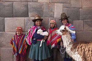 Lamb Gallery: South America, Peru, Cusco. Quechua people standing in front of an Inca wall, holding