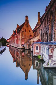 St. John hospital (Sint-Janshospitaal, now a museum) reflecting in the water canal St. John hospital (Sint-Janshospitaal, now a museum) reflecting in the water canal