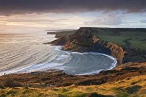 Images Dated 14th February 2011: Storm light illuminates Chapmans Pool and Houns Tout cliff, viewed from St Aldhelms Head