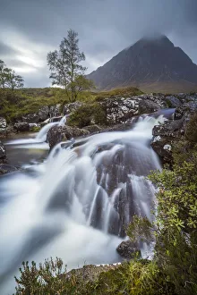 Stream flowing through rocks against Buchaille Etive Mor mountain in Glen Coe, Highland Stream flowing through rocks against Buchaille Etive Mor mountain in Glen Coe, Highland