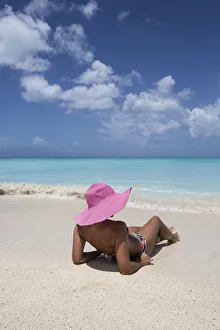 Sunbathe on the beach facing the turquoise water of the Caribbean sea, The Nest, Antigua Sunbathe on the beach facing the turquoise water of the Caribbean sea, The Nest, Antigua