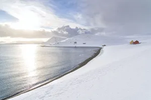 Sunlight reflected in the cold sea surrounded by snow, Skarsvag, Nordkapp Sunlight reflected in the cold sea surrounded by snow, Skarsvag, Nordkapp
