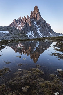 Sunrise of Mount Paterno reflected in a puddle, Natural Park Three Peaks, Sesto Pusteria Sunrise of Mount Paterno reflected in a puddle, Natural Park Three Peaks, Sesto Pusteria