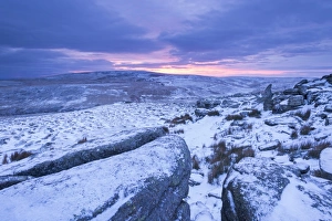 Sunrise above a snow covered moorland, Belstone Tor, Dartmoor National Park, Devon Sunrise above a snow covered moorland, Belstone Tor, Dartmoor National Park, Devon