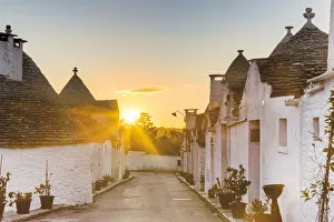 Sunrise between trulli houses. Unesco World Heritage Site, Alberobello, Province of Bari Sunrise between trulli houses. Unesco World Heritage Site, Alberobello, Province of Bari