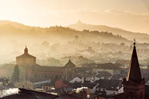 Sunset in Bologna, rooftops and hills in background with Santuario di San Luca Sunset in Bologna, rooftops and hills in background with Santuario di San Luca