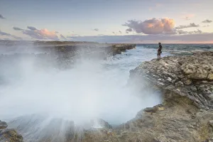 Sunset on the cliffs of Devils Bridge submerged by crashing waves Caribbean Antigua Sunset on the cliffs of Devils Bridge submerged by crashing waves Caribbean Antigua