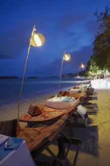 Tables set for dinner at Amari Palm Reef on Chaweng beach at dusk, Ko Samui, Thailand Tables set for dinner at Amari Palm Reef on Chaweng beach at dusk, Ko Samui, Thailand