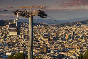 Teleferic de Montjuic or aerial tramway with city skyline at sunset, Barcelona, Catalonia Teleferic de Montjuic or aerial tramway with city skyline at sunset, Barcelona, Catalonia