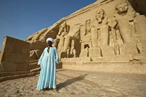 Lake Nasser Gallery: A temple guardian stands in front of the facade of Abu Simbel