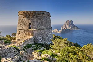 Torre des Savinar defence tower with Es Vedra island in the background, Ibiza Torre des Savinar defence tower with Es Vedra island in the background, Ibiza