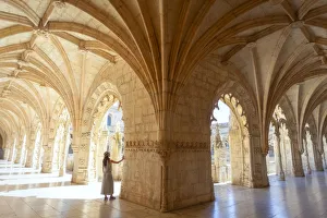 A tourist observes the columns of the cloister of the Mosteiro dos Jeronimos A tourist observes the columns of the cloister of the Mosteiro dos Jeronimos