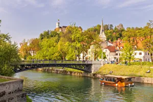 Touristic boat on Ljubljanica river near Hradecky Bridge Touristic boat on Ljubljanica river near Hradecky Bridge
