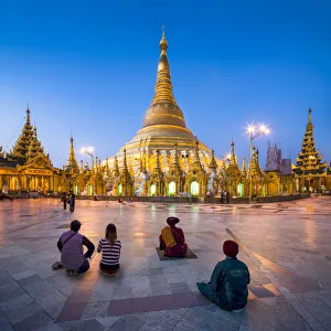 Tourists praying at the Shwedagon Pagoda in Yangon, Yangon Region, Myanmar Tourists praying at the Shwedagon Pagoda in Yangon, Yangon Region, Myanmar