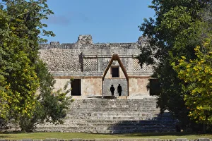 Stone Carvings Gallery: Tourists visiting the ancient Mayan town of Uxmal, Yucatan, Mexico