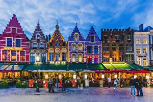 Tourists walking in Market Square in Bruges, Belgium Tourists walking in Market Square in Bruges, Belgium