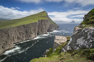Towering sea cliffs on the island of Vagar in the Faroe Islands, Denmark. Summer Towering sea cliffs on the island of Vagar in the Faroe Islands, Denmark. Summer