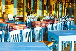 Traditional blue tables and chairs of a Greek restaurant (taverna), Chania, Crete, Greece Traditional blue tables and chairs of a Greek restaurant (taverna), Chania, Crete, Greece