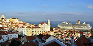 The traditional and moorish Alfama district and a cruise ship on the Tagus river. Lisbon