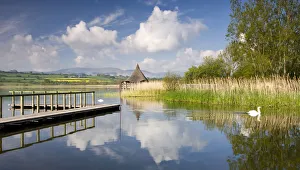 Tranquil morning on Llangorse Lake, with views to the Iron Age Crannog and Pen y Fan Tranquil morning on Llangorse Lake, with views to the Iron Age Crannog and Pen y Fan