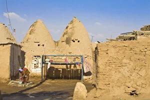 Images Dated 18th August 2008: Turkey, Eastern Turkey, Harran, Bed outside Traditional mud brick Beehive houses