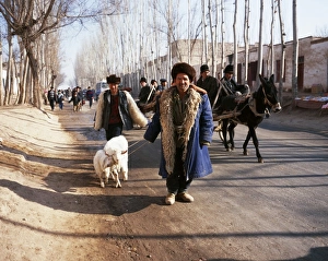 Uighur man with sheep on the road to Kashgar market Uighur man with sheep on the road to Kashgar market