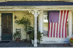 USA, Maine, Cundys Harbor, US flag on porch USA, Maine, Cundys Harbor, US flag on porch