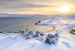 Veines village covered with snow lit by sunrise, Kongsfjord, Varanger Peninsula Veines village covered with snow lit by sunrise, Kongsfjord, Varanger Peninsula