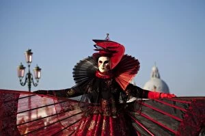 Images Dated 16th June 2008: Venice, Veneto, Italy; A mask in costume on the Bacino di San Marco with the cupola of Santa Maria