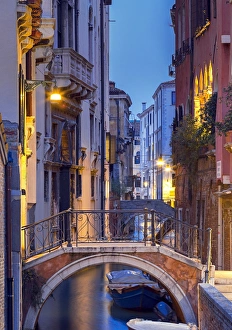 Venice, Veneto, Italy. View over a bridge and a canal at dusk Venice, Veneto, Italy. View over a bridge and a canal at dusk