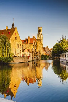 View of Bruges old town reflecting in the water canal at sunrise, Belgium View of Bruges old town reflecting in the water canal at sunrise, Belgium