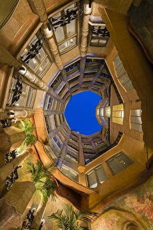 Bottom view of the inner courtyard of Casa Mila or La Pedrera at dusk, Barcelona Bottom view of the inner courtyard of Casa Mila or La Pedrera at dusk, Barcelona