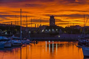 View of Port Vell harbor at sunset with dramatic red sky, Barcelona, Catalonia, Spain View of Port Vell harbor at sunset with dramatic red sky, Barcelona, Catalonia, Spain