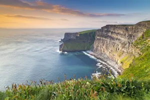 View of a sunset at the Cliffs of Moher. County Clare, Munster province, Ireland View of a sunset at the Cliffs of Moher. County Clare, Munster province, Ireland