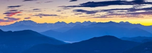 View towards Swiss Alps from Monte San Salvatore illuminated at sunset, Lugano, Lake Lugano View towards Swiss Alps from Monte San Salvatore illuminated at sunset, Lugano, Lake Lugano