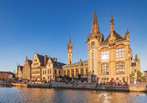View of the waterfront buildings in Ghent reflecting in the water canal at sunset View of the waterfront buildings in Ghent reflecting in the water canal at sunset