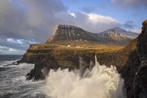 The village of Gasadalur and its waterfal hit by a storm. Island of Vagar. Faroe Islands The village of Gasadalur and its waterfal hit by a storm. Island of Vagar. Faroe Islands