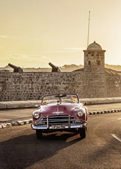 Vintage Car at El Malecon with San Salvador de la Punta Castle in the background, sunrise Vintage Car at El Malecon with San Salvador de la Punta Castle in the background, sunrise