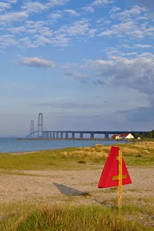 Warm afternoon light illuminates a sandy beach leading towards the East Bridge, Korsor Warm afternoon light illuminates a sandy beach leading towards the East Bridge, Korsor