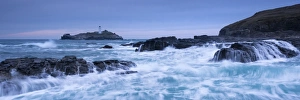 Waves crash around the rocks near Godrevy Lighthouse, Cornwall, England. Winter Waves crash around the rocks near Godrevy Lighthouse, Cornwall, England. Winter