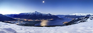 Wide angle shot of Alto Lario with Como lake and mount Legnone lighted by the moon in winter Wide angle shot of Alto Lario with Como lake and mount Legnone lighted by the moon in winter