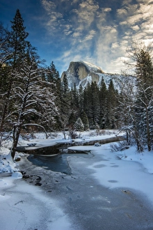 Winter view over icy Tenaya creek with Half Dome mountain behind, Yosemite National Park Winter view over icy Tenaya creek with Half Dome mountain behind, Yosemite National Park