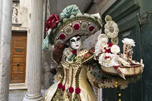 A woman in a beautiful costume poses during the Venice Carnival, Venice; Veneto; Italy A woman in a beautiful costume poses during the Venice Carnival, Venice; Veneto; Italy