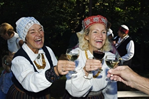 Woman in Traditional Dress enjoying Food and Wine at Woman in Traditional Dress enjoying Food and Wine at