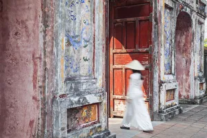 Woman wearing Ao Dai dress at Dien Tho inside Citadel, Hue, Thua Thien-Hue, Vietnam (MR) Woman wearing Ao Dai dress at Dien Tho inside Citadel, Hue, Thua Thien-Hue, Vietnam (MR)