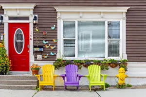 Wooden colorful dechchairs in front of traditional house in St Johns downtown Wooden colorful dechchairs in front of traditional house in St Johns downtown