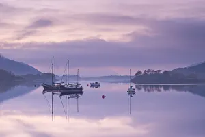 Yachts moored on a tranquil Loch Leven at twilight, Glencoe, Highland, Scotland. Autumn Yachts moored on a tranquil Loch Leven at twilight, Glencoe, Highland, Scotland. Autumn