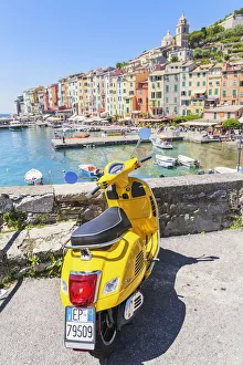 Yellow Vespa scooter parked near harbour, Portovenere, La Spezia district, Liguria, Italy Yellow Vespa scooter parked near harbour, Portovenere, La Spezia district, Liguria, Italy