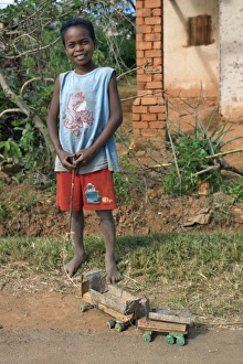 A young boy proudly displays his homemade toy truck A young boy proudly displays his homemade toy truck